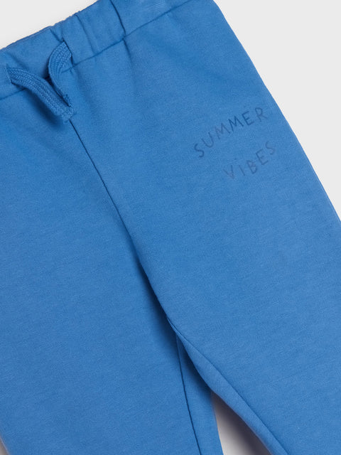 Blue sweatpants with 'Summer Vibes' text on a white background