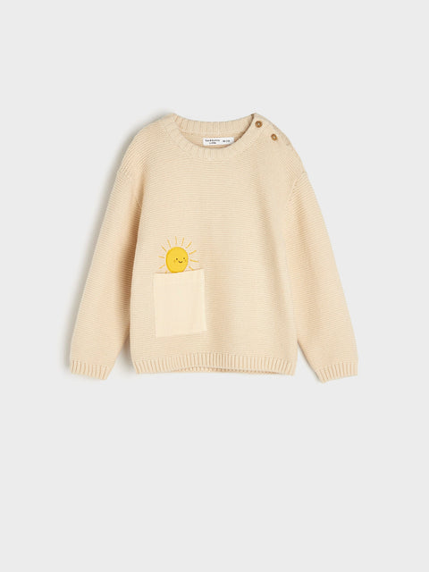 Beige sweater with a pocket and yellow heart design on a light gray background