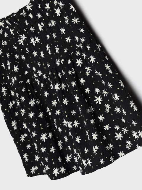 Black fabric with white floral pattern on a white background
