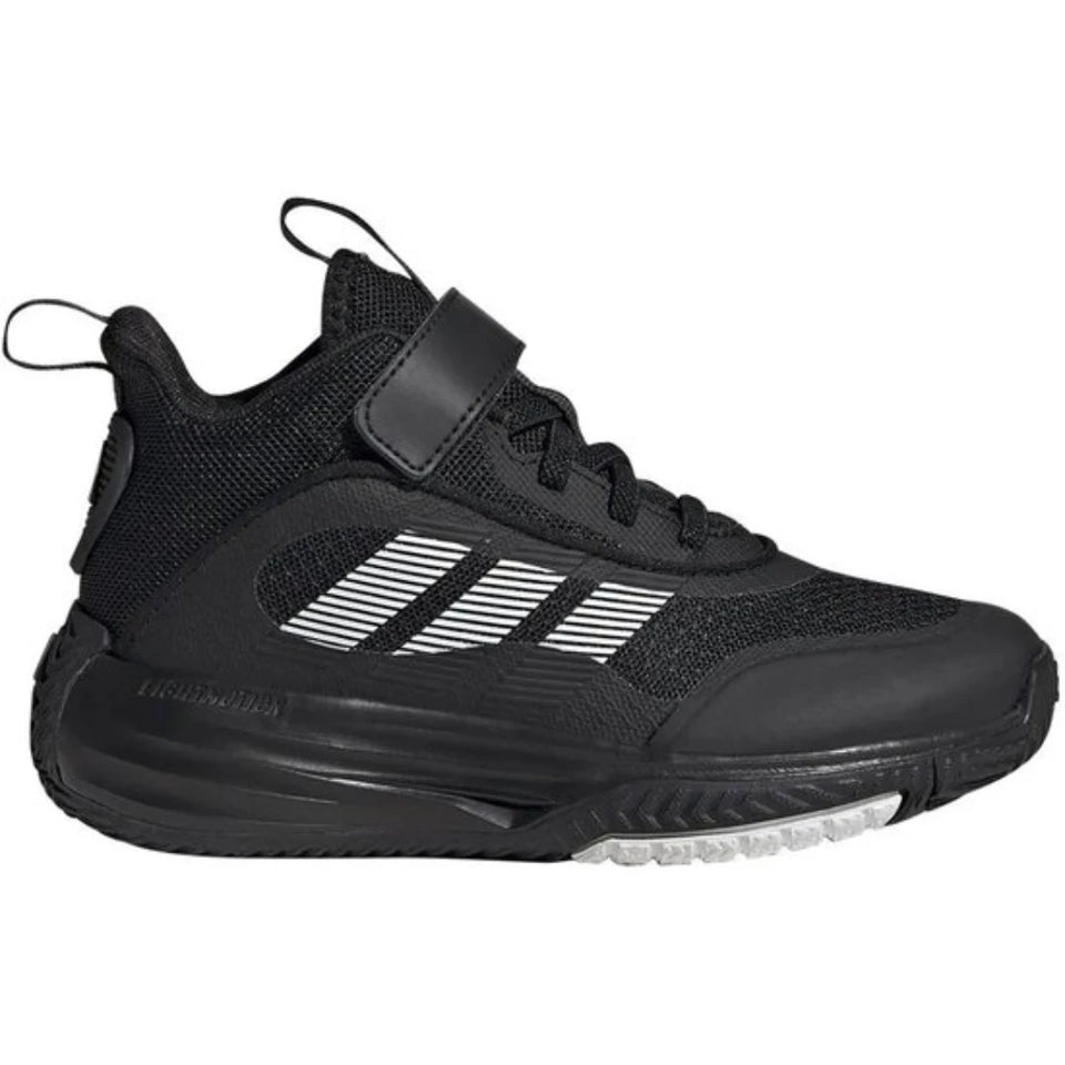 A black Adidas athletic shoe with a hook-and-loop strap closure and white three-stripes branding on the side, shown against a plain white background.