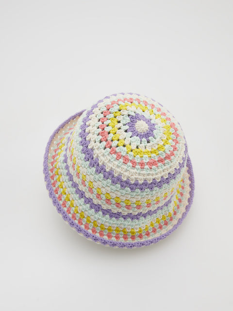 Colorful crocheted hat on a white background