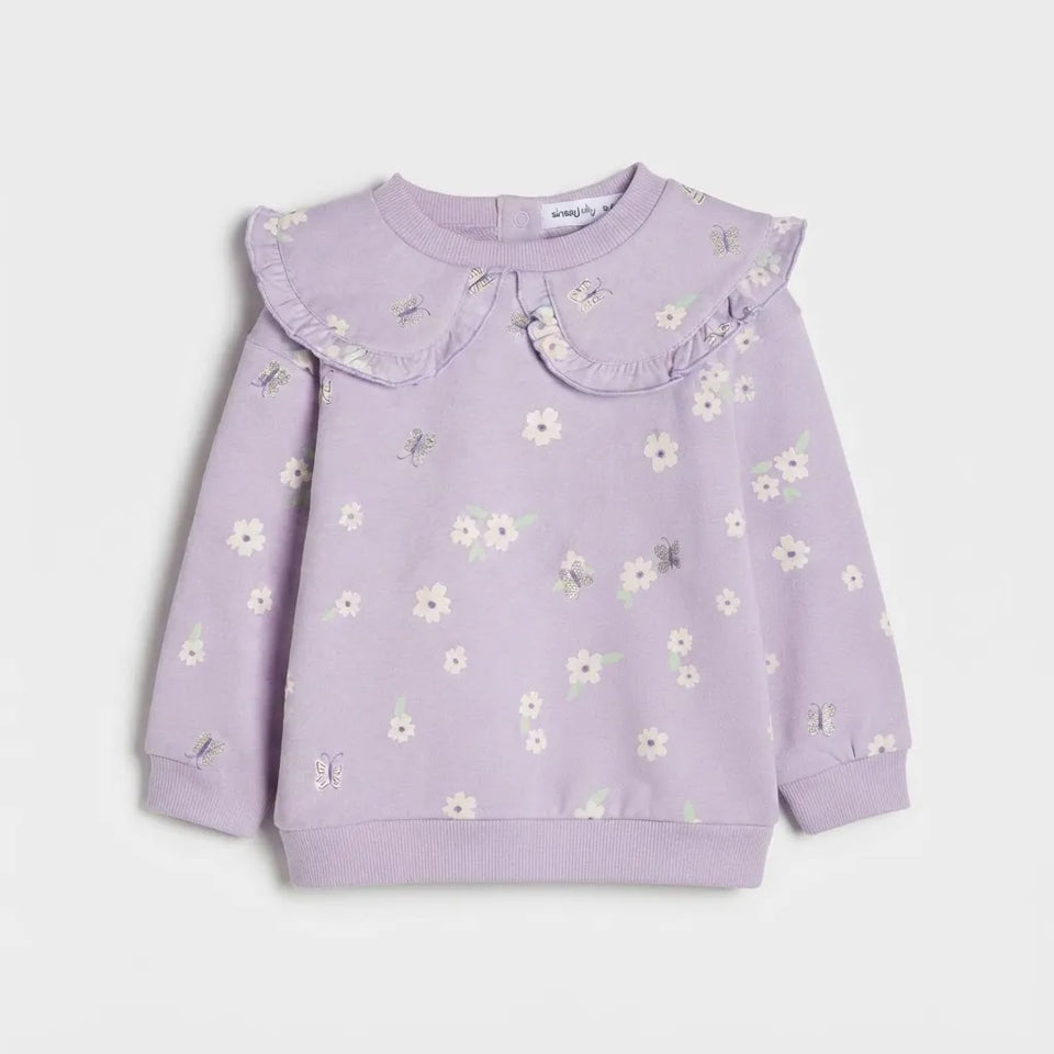 A lavender long-sleeve sweatshirt for toddlers, featuring a ruffled Peter Pan collar and a delicate all-over floral and dragonfly print, shown flat on a light gray background.