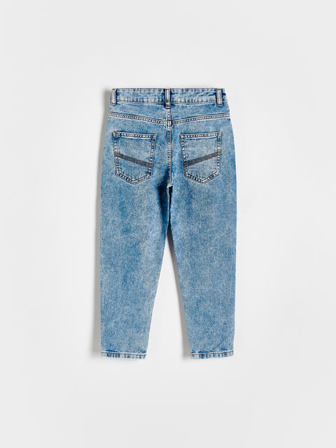 Back view of a pair of blue jeans on a white background