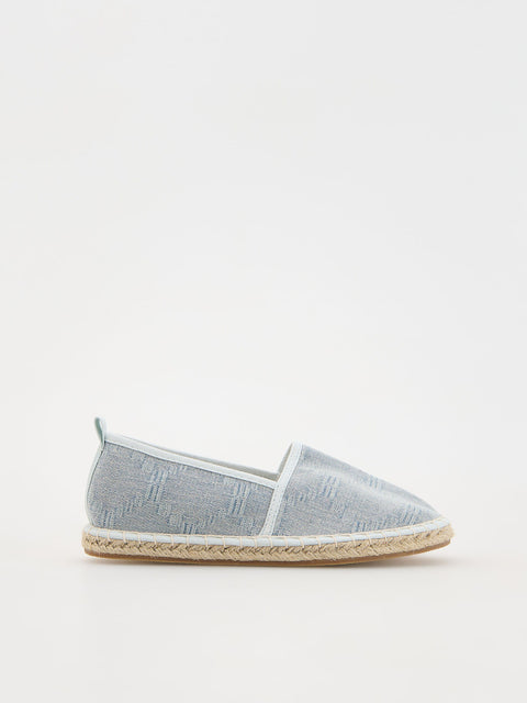 Light gray espadrille shoe on a white background