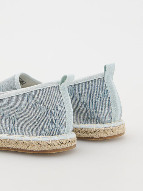 Pair of light blue espadrilles with jute sole on a white background