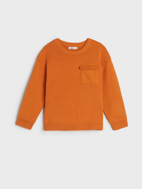 Orange sweater with a pocket on a light gray background
