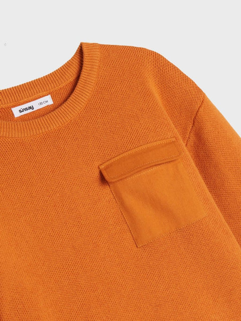 Close-up of an orange sweater with a pocket on a light gray background