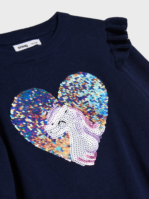 Navy blue sweater with a colorful sequin heart and unicorn design on a light gray background