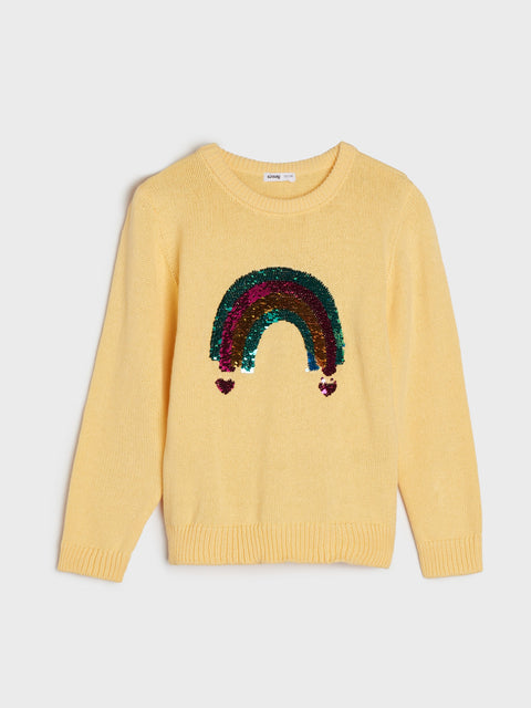 Yellow sweater with a colorful rainbow design on a light gray background