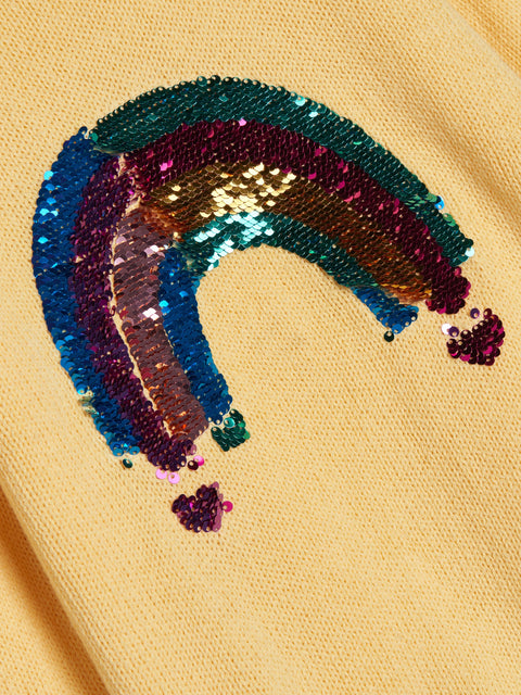 Sequined rainbow design on a yellow background