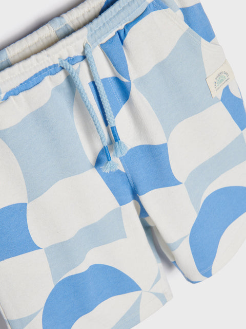 Close-up of a patterned fabric with blue and white shapes on a white background