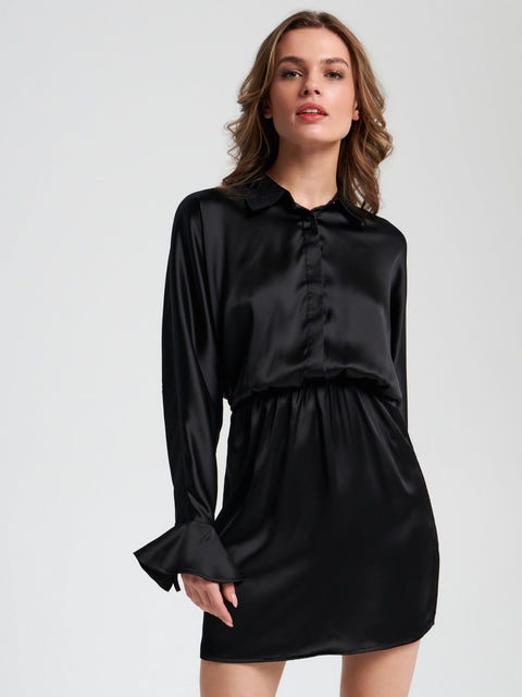 Woman wearing a black satin dress on a white background