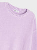 Close-up of a lavender sweater with a brand label on a light gray background