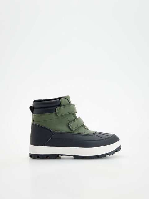 Green and black winter boot on a white background