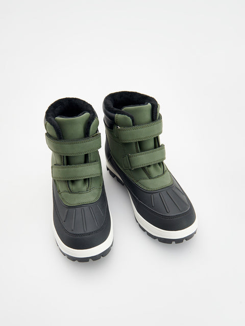 Pair of green and black winter boots on a white background