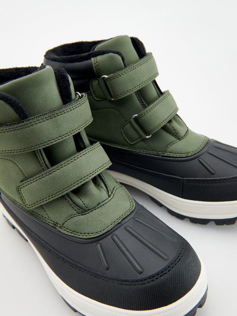 Green and black winter boots with velcro straps on a white background