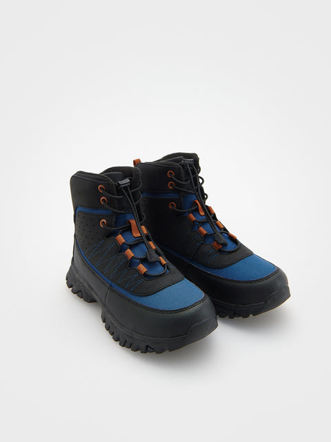 Pair of black and blue boots with orange accents on a white background