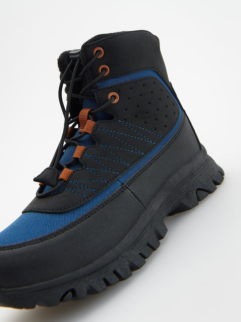 Black and blue hiking boot on a white background