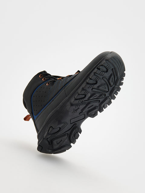 Black hiking boot with a textured sole on a light gray background
