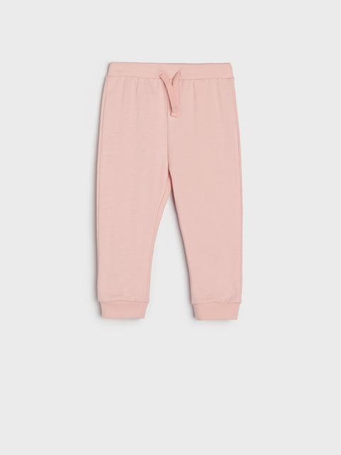 Pink sweatpants on a light gray background
