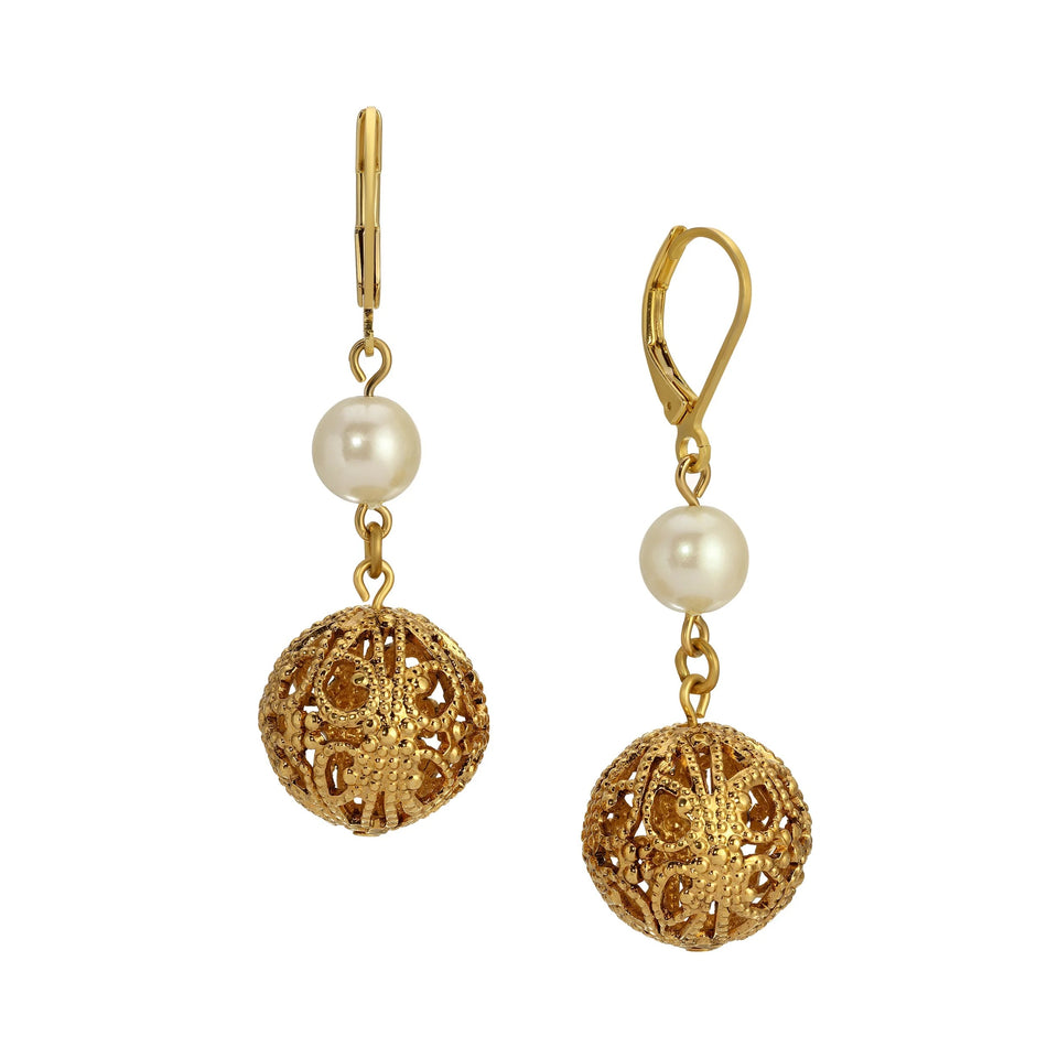 A pair of gold leverback drop earrings featuring a round white pearl and an intricate filigree gold ball dangle, shown against a plain white background.