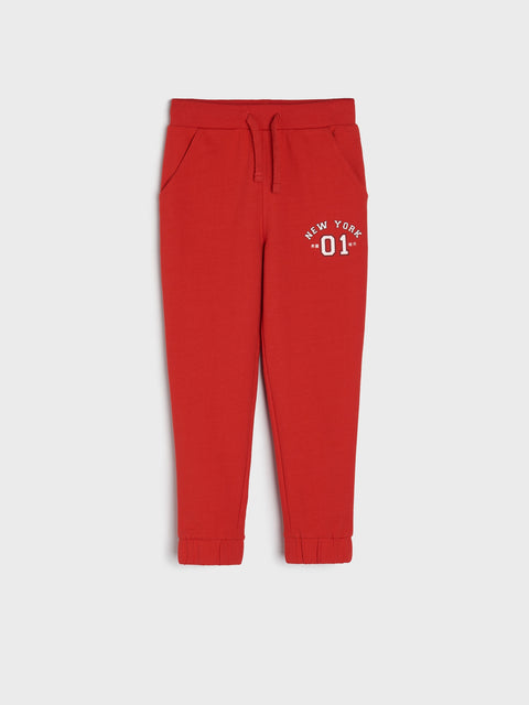 Red sweatpants with 'New York 01' text on a white background