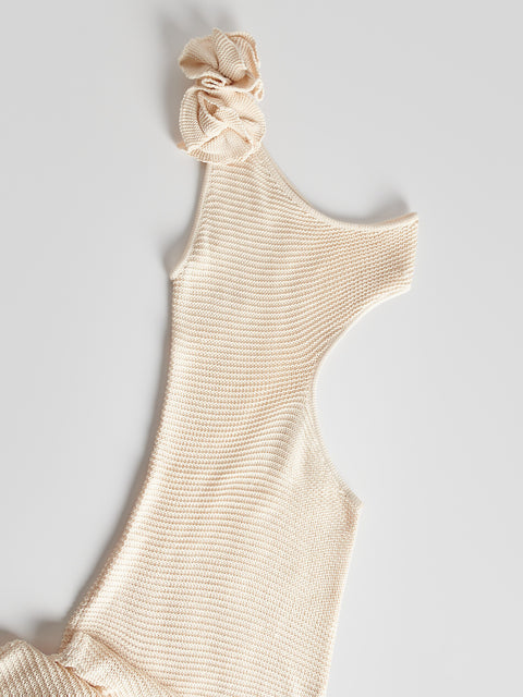 Beige one-shoulder dress with a matching scrunchie on a light gray background