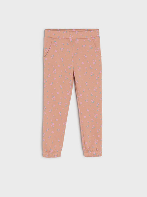 Pink pants with a subtle pattern on a white background