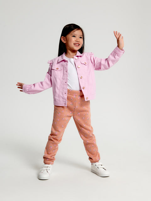 Child wearing a pink jacket and pants on a white background