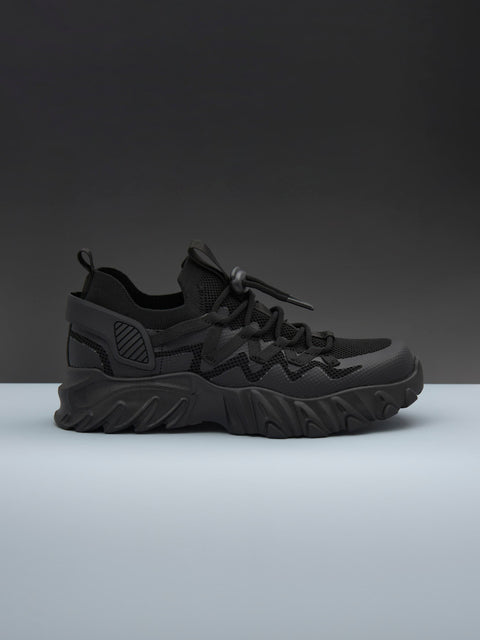 Black sneaker on a gray background