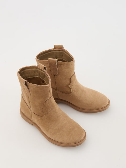 Pair of tan ankle boots on a white background
