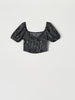 Black beaded top on a light gray background