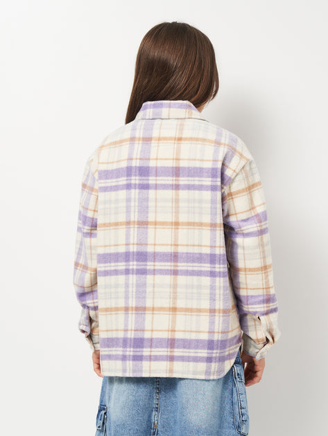 Person wearing a plaid shirt with purple and beige colors on a white background