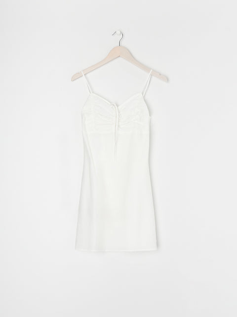 White dress on a hanger against a white background