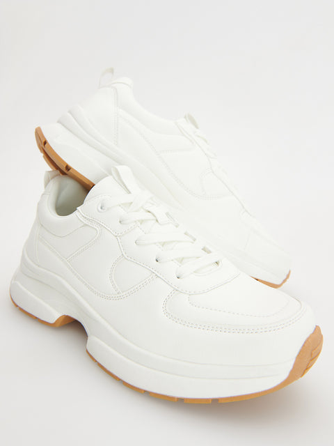 White sneakers with brown soles on a white background