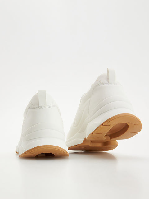 White sneakers with brown soles on a white background