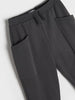 Dark gray pants on a light gray background