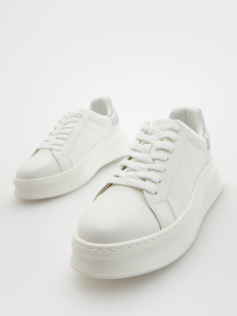 White sneakers on a light gray background