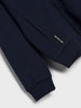 Navy blue jacket with a brand label on a light gray background