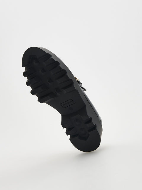 Black sole of a shoe on a light gray background