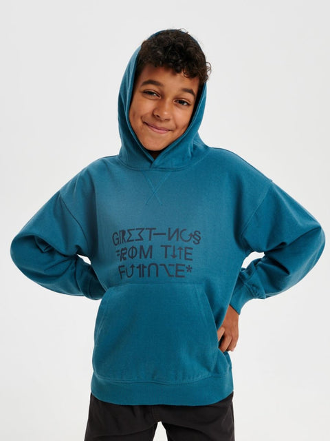Child wearing a blue hoodie with text on a white background