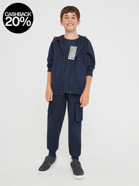 Child wearing a navy blue tracksuit on a white background