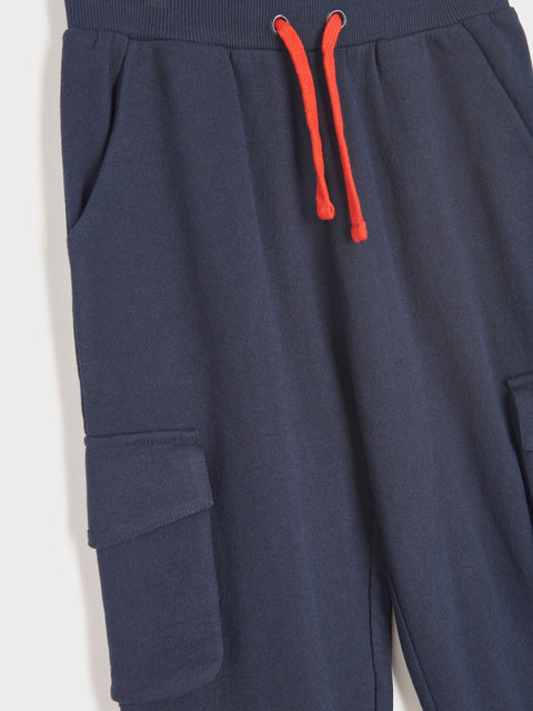 Navy blue cargo pants with red drawstring on a white background
