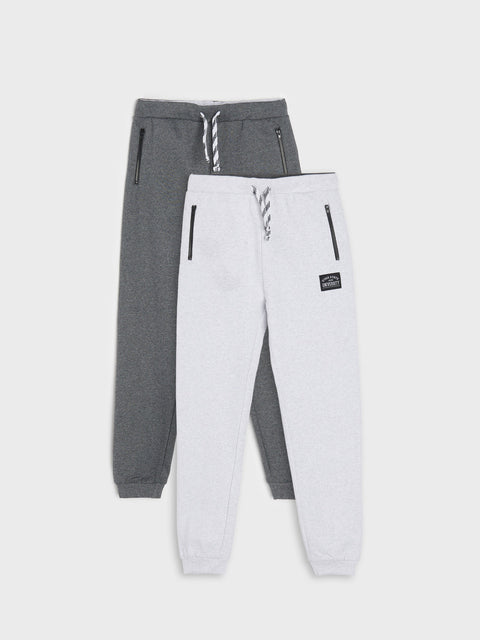 Gray and white jogger pants on a light gray background