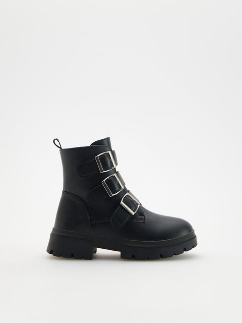 Black boot with silver buckles on a white background