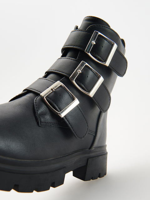 Black boot with silver buckles on a white background