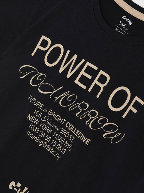 Black t-shirt with beige text and branding on a black background
