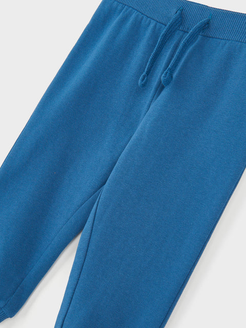 Blue sweatpants on a light gray background
