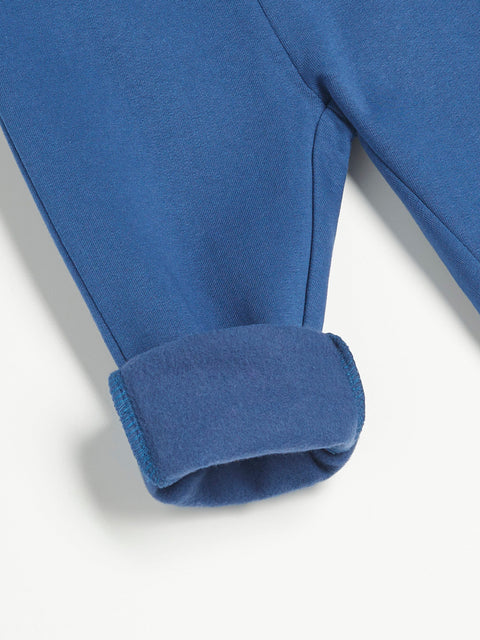 Close-up of a blue fleece jacket sleeve on a white background