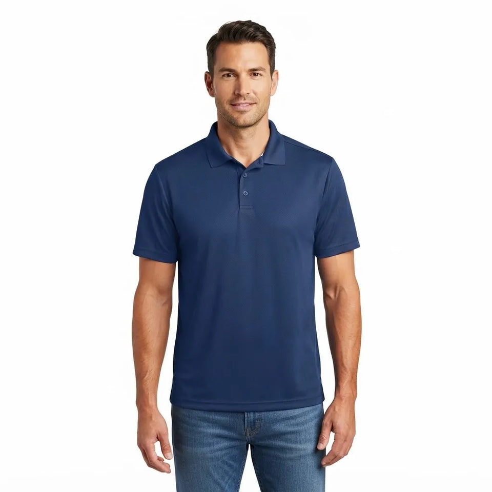 A man wearing a navy blue short-sleeve polo shirt and blue jeans, standing against a plain white background.